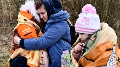 A mother hugs her daughter at a checkpoint run by local volunteers after arriving from Ukraine, crossing the border in Beregsurany, Hungary. (AP)