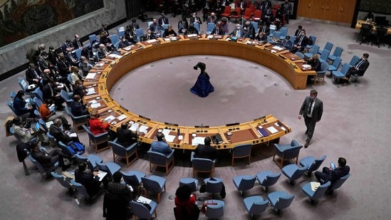 Ukraine Permanent Representative to the United Nations Sergiy Kyslytsya (R) walks to his seat during an emergency meeting of the UN Security Council on Ukraine in New York on February 23, 2022.(AFP)