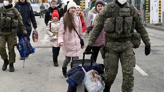 Ukraine crisis: Slovak customs officers help people to cross the border as they arrive from Ukraine to Slovakia, after Russia launched a massive military operation against Ukraine. Ukraine crisis: Slovak customs officers help people to cross the border as they arrive from Ukraine to Slovakia, after Russia launched a massive military operation against Ukraine.