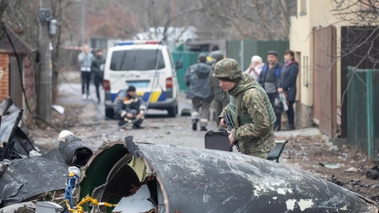 A Ukrainian Army soldier inspects fragments of a downed aircraft in Kyiv, Ukraine, Friday, February. 25, 2022. &nbsp;(AP/PTI)