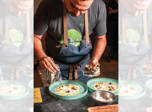 Avinash plates up tender coconut carpaccio, saffron leche de tegre, fresh mountain berries and pickled shallots Avinash plates up tender coconut carpaccio, saffron leche de tegre, fresh mountain berries and pickled shallots