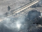 Ukrainian soldiers walk past debris of a burning military truck, on a street in Kyiv, Ukraine, Saturday, Feb. 26, 2022. (AP Photo/Efrem Lukatsky)(AP) Ukrainian soldiers walk past debris of a burning military truck, on a street in Kyiv, Ukraine, Saturday, Feb. 26, 2022. (AP Photo/Efrem Lukatsky)(AP)