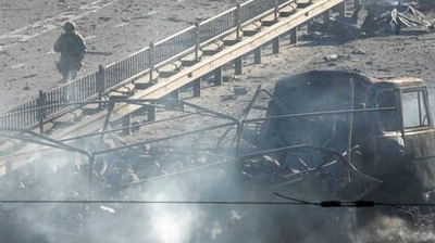 Ukrainian soldiers walk past debris of a burning military truck, on a street in Kyiv, Ukraine, Saturday, Feb. 26, 2022. (AP Photo/Efrem Lukatsky) (AP) Ukrainian soldiers walk past debris of a burning military truck, on a street in Kyiv, Ukraine, Saturday, Feb. 26, 2022. (AP Photo/Efrem Lukatsky) (AP)
