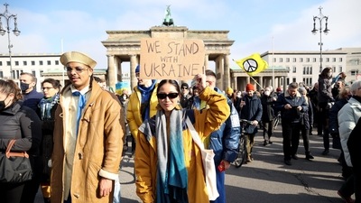 An anti-war protester against the Russian invasion of Ukraine holds a placard at the Brandenburg Gate in Berlin, Germany. (Bloomberg) An anti-war protester against the Russian invasion of Ukraine holds a placard at the Brandenburg Gate in Berlin, Germany. (Bloomberg)