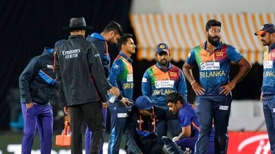 Indian team doctor checks Ishan Kishan, sitting center right, after a ball hits on his helmet during the second Twenty20 international cricket match between India and Sri Lanka, in Dharmsala, India, Saturday, Feb. 26, 2022 (AP) Indian team doctor checks Ishan Kishan, sitting center right, after a ball hits on his helmet during the second Twenty20 international cricket match between India and Sri Lanka, in Dharmsala, India, Saturday, Feb. 26, 2022 (AP)