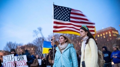 Activists hold Ukranian and US flags as they protest against Russia's invasion of Ukraine during a rally at Lafayette Square, across from the White House, in Washington, DC. (AFP)