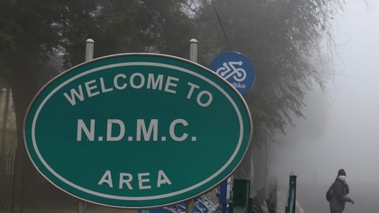 A commuter seen next to an NDMC signage at Tilak Marg in New Delhi on January 16.(Arvind Yadav / HT Photo) A commuter seen next to an NDMC signage at Tilak Marg in New Delhi on January 16.(Arvind Yadav / HT Photo)