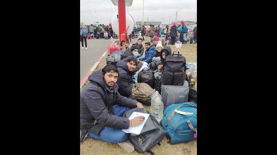 The students sitting in the open, in freezing temperature. (Sourced)