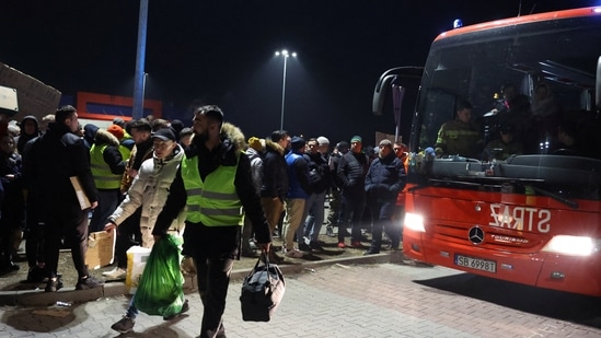 Przemysl, Poland: People wait in a parking lot for buses to arrive with refugees after Russia's invasion against Ukraine on February 26, 2022.&nbsp;(Reuters photo)