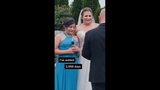 The Instagram video shows the girl handing her adoption papers to her mom's husband-to-be at their wedding.(instagram/@tjdukesfilms)