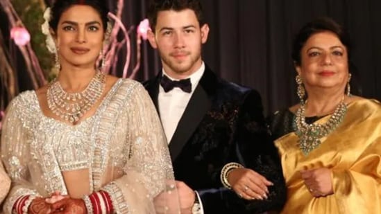 Priyanka Chopra and Nick Jonas with her mother during their wedding reception in Delhi in 2018.