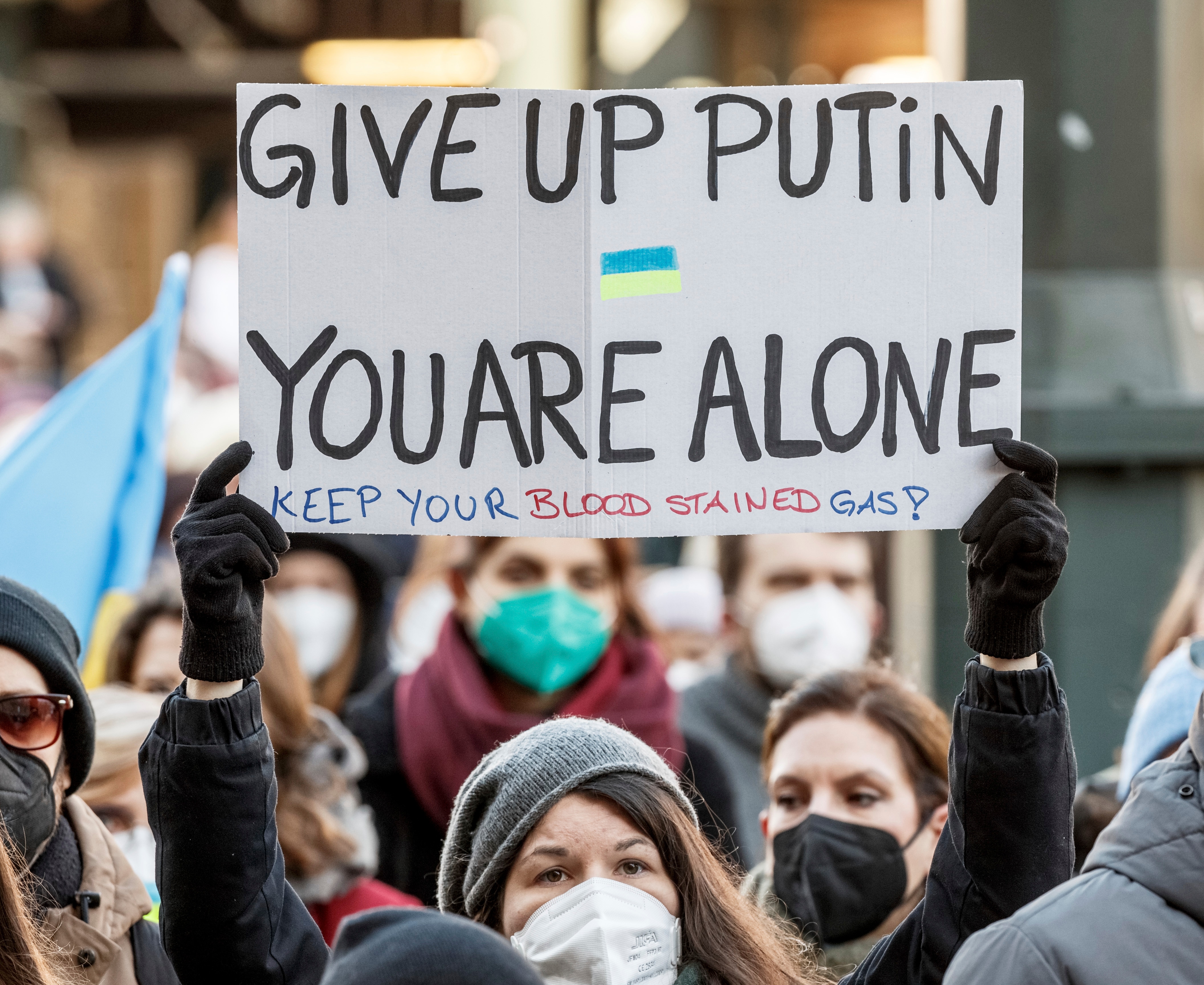 A rally participant holds up a sign reading "Give up Putin, you are alone" during a demonstration at the Rathausmarkt against the Russian attack on Ukraine in Hamburg, Germany, Sunday, February 27, 2022 (AP) A rally participant holds up a sign reading "Give up Putin, you are alone" during a demonstration at the Rathausmarkt against the Russian attack on Ukraine in Hamburg, Germany, Sunday, February 27, 2022 (AP)
