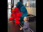 Screengrab from the video that shows the toddler meeting Cookie Monster and Elmo. (instagram/@almosttripletsnyc)