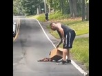 Screengrab from the video that shows a man rescuing a baby deer from traffic.&nbsp;