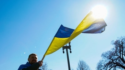 A demonstrator holds a Ukrainian flag during a "Stand with Ukraine" rally against the Russian invasion of Ukraine, in front of the White House in Washington, U.S., February 28, 2022.&nbsp; (REUTERS)