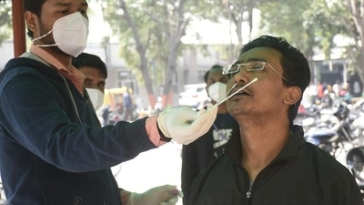 A health worker collects swab samples for Covid-19 test at the Combined District Hospital, Sanjay Nagar, in Ghaziabad. (Sakib Ali /HT)