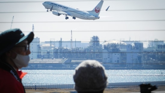 A Japan Airlines Co., Ltd. (JAL) aircraft takes off at Haneda Airport in Tokyo, Japan, on Saturday, Feb. 26, 2022. The first phase of Japan's easing on quarantine rules starts from March 1, when new foreign entrants except for tourists will be admitted. The government will cap the number of daily arrivals at 5,000 compared with the current 3,500 for the time being.&nbsp;(Photographer: Kentaro Takahashi/Bloomberg)