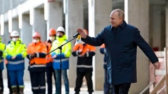 Russian President Vladimir Putin gestures as he leaves the construction site of the National Space Agency in Moscow.(AP)