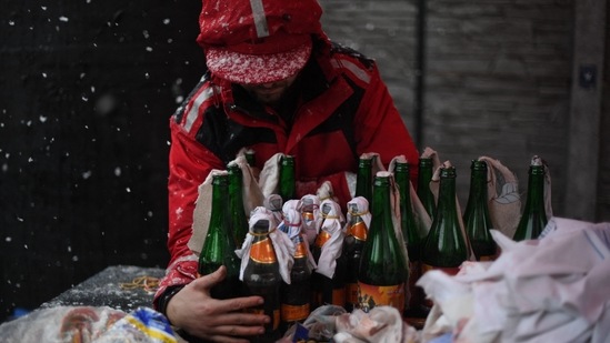 A volunteer demonstrates the preparation of Molotov cocktails at the Pravda - (Truth) brewery in Lviv.(AFP)