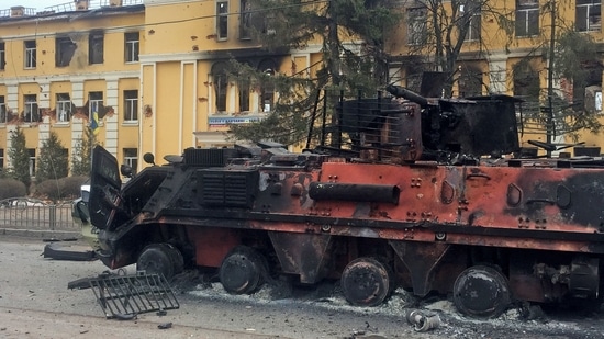 A destroyed armoured vehicle is seen in front of a school which, according to local residents, was on fire after shelling in Kharkiv, Ukraine.(REUTERS)