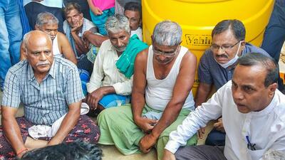 Relatives and friends gather at the residence of Naveen Shekharappa, a final year medical student, who passed away due to Russian shelling in Kharkiv, at Chalageri village in Haveri on Tuesday. (PTI)