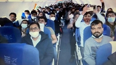 Indian nationals wave tricolour after their flight reached Delhi airport from Bucharest.&nbsp; (Twitter/ANI)
