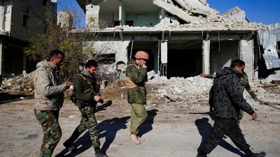 File photo of Russian and Syrian army soldiers gathering at the last checkpoint before the front line with rebels, in Karam al-Tarab, east of Aleppo. (AP)