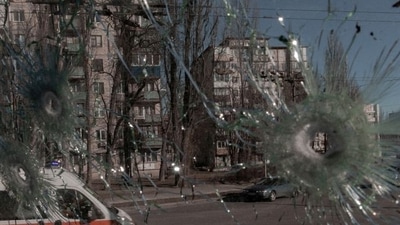 FILE PHOTO: An ambulance is seen through the damaged window of a vehicle hit by bullets, as Russia's invasion of Ukraine continues, in Kyiv, REUTERS (Agencja Wyborcza.pl via REUTERS)