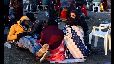 Refugees brave the cold in a frozen field after they fled from Ukraine because of the Russian invasion at the border checkpoint in Medyka, Poland. (REUTERS) Refugees brave the cold in a frozen field after they fled from Ukraine because of the Russian invasion at the border checkpoint in Medyka, Poland. (REUTERS)