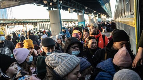 Displaced Ukrainians seeking to leave the capital city board a train at Kyiv central train station in Kyiv, Ukraine, on Sunday. (Bloomberg) Displaced Ukrainians seeking to leave the capital city board a train at Kyiv central train station in Kyiv, Ukraine, on Sunday. (Bloomberg)