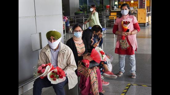 Relatives awaiting the arrival of Indian nationals evacuated from war-torn Ukraine at the Indira Gandhi International Airport in New Delhi on Tuesday. (PTI)