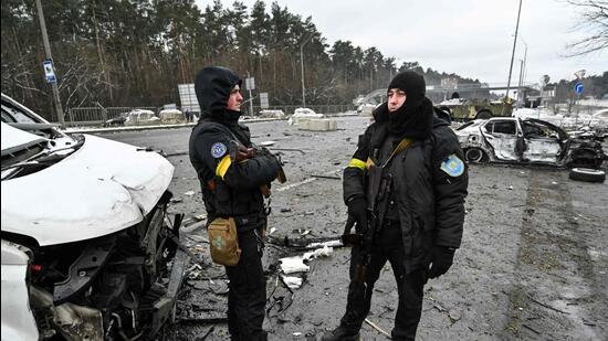 Armed men stand on a check-point in the city of Brovary outside Kyiv, Ukraine on Tuesday. (AFP)