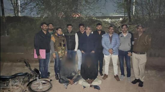 The police team with the two suspects. According to the police, at least 22 bullets were exchanged between a police team and the two gangsters before they were arrested. (Sourced)