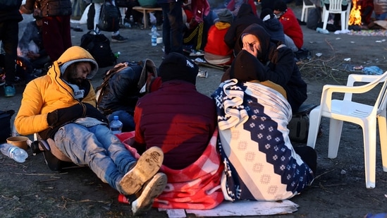 Refugees brave the cold in a frozen field after they fled from Ukraine because of the Russian invasion at the border checkpoint in Medyka, Poland.