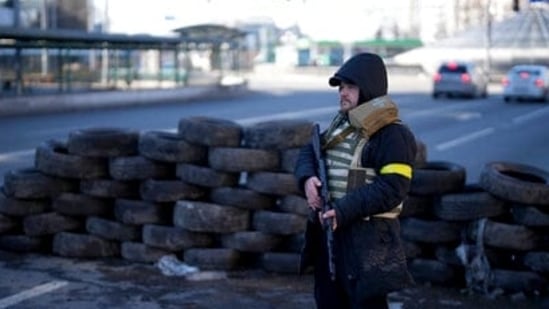 A civil defenseman stands at a checkpoint in Kyiv, Ukraine, Saturday. &nbsp;(AP)
