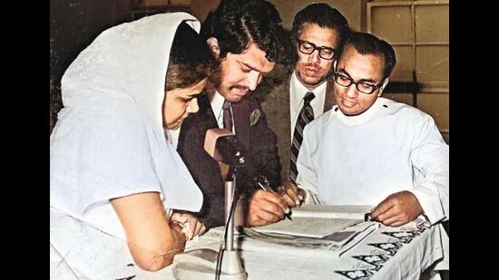 Usha and Jani signing the register after getting married at the Mar Thoma Syrian Church in Delhi, as her father-in-law watches