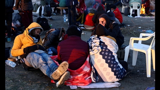 Refugees brave the cold in a frozen field after they fled from Ukraine because of the Russian invasion at the border checkpoint in Medyka, Poland. (REUTERS)