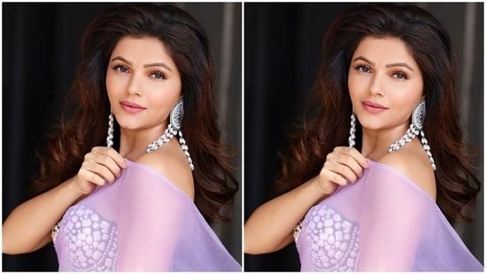 Rubina further teamed the saree with a strapless bustier-style blouse in a black hue and embroidered with reflective silver sequins and beads. It also features a plunging sweetheart neckline, bodycon silhouette, and a midriff-baring hem length.(Instagram/@rubinadilaik)