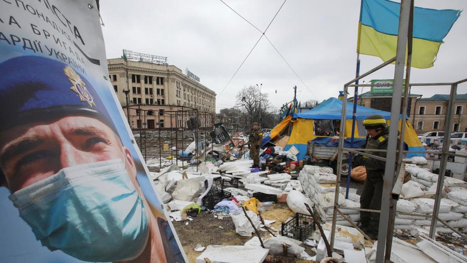 Ukrainian service members stand guard outside the regional administration building, which city officials said was hit by a missile attack, in central Kharkiv, Ukraine, March 1 (Reuters)