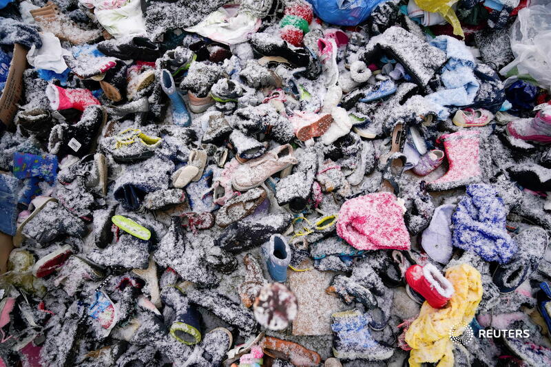 Piles of clothing lined the potholed road as people sought to lighten their load. (REUTERS) Piles of clothing lined the potholed road as people sought to lighten their load. (REUTERS)