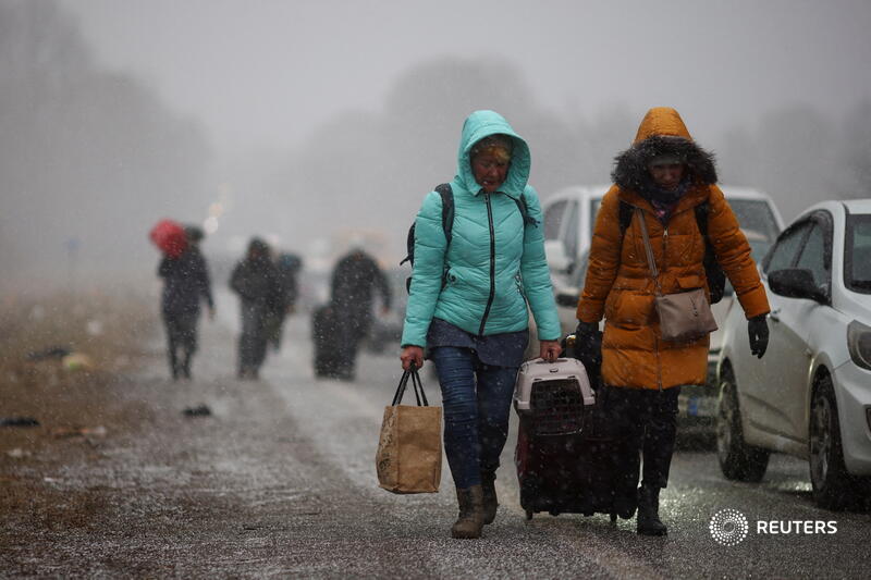 Long queues form at central Europe border crossings as people flee Ukraine.(REUTERS)