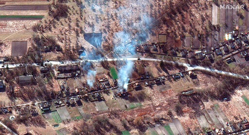 This satellite image provided by Maxar Technologies shows part of military convoy and burning homes northwest of Invankiv, Ukraine. (AP)