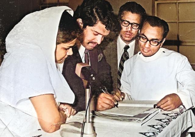 Usha and Jani signing the register after getting married at the Mar Thoma Syrian Church in Delhi, as her father-in-law watches Usha and Jani signing the register after getting married at the Mar Thoma Syrian Church in Delhi, as her father-in-law watches