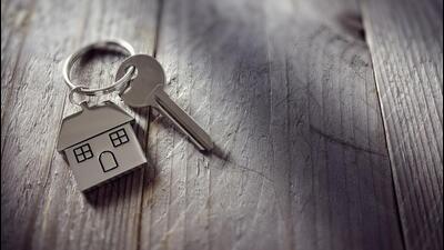House key on a house shaped keychain resting on wooden floorboards concept for real estate, moving home or renting property (Getty Images/iStockphoto) House key on a house shaped keychain resting on wooden floorboards concept for real estate, moving home or renting property (Getty Images/iStockphoto)