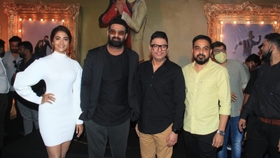 While Prabhas looked dapper in his all-black attire, Pooja Hegde complimented the actor in a white ribbed dress. (HT Photo/Varinder Chawla) While Prabhas looked dapper in his all-black attire, Pooja Hegde complimented the actor in a white ribbed dress. (HT Photo/Varinder Chawla)