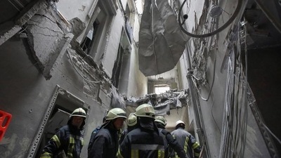 Rescuers remove debris in the regional administration building, which city officials said was hit by a missile attack, in central Kharkiv, Ukraine, Tuesday. (REUTERS)