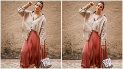 Neha Dhupia's outfit comprised of a neutral oversized shirt and an orange pleated skirt. (Instagram/@nehadhupia)