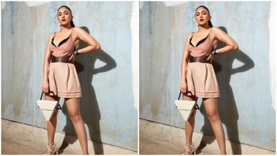 Mrunal decked up in a midriff-baring pastel short dress that came layered in black and a golden belt detail at the waist. The slip-in dress hugged Mrunal's shape perfectly and showed off her curves. (Instagram/@mrunalthakur)