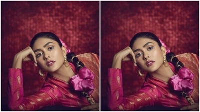 Mrunal can do ethnic with equal sass. A few days back, Mrunal shared a set of pictures where she went traditional in a bright orange and golden benarasi saree from the house of Weaver Story. (Instagram/@mrunalthakur)