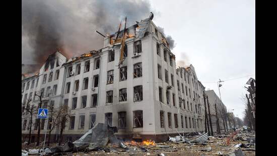 Firefighters work to contain a fire at the Economy Department building of Karazin Kharkiv National University, allegedly hit during recent shelling by Russia, on March 2, 2022. (Photo by Sergey BOBOK / AFP) (AFP)